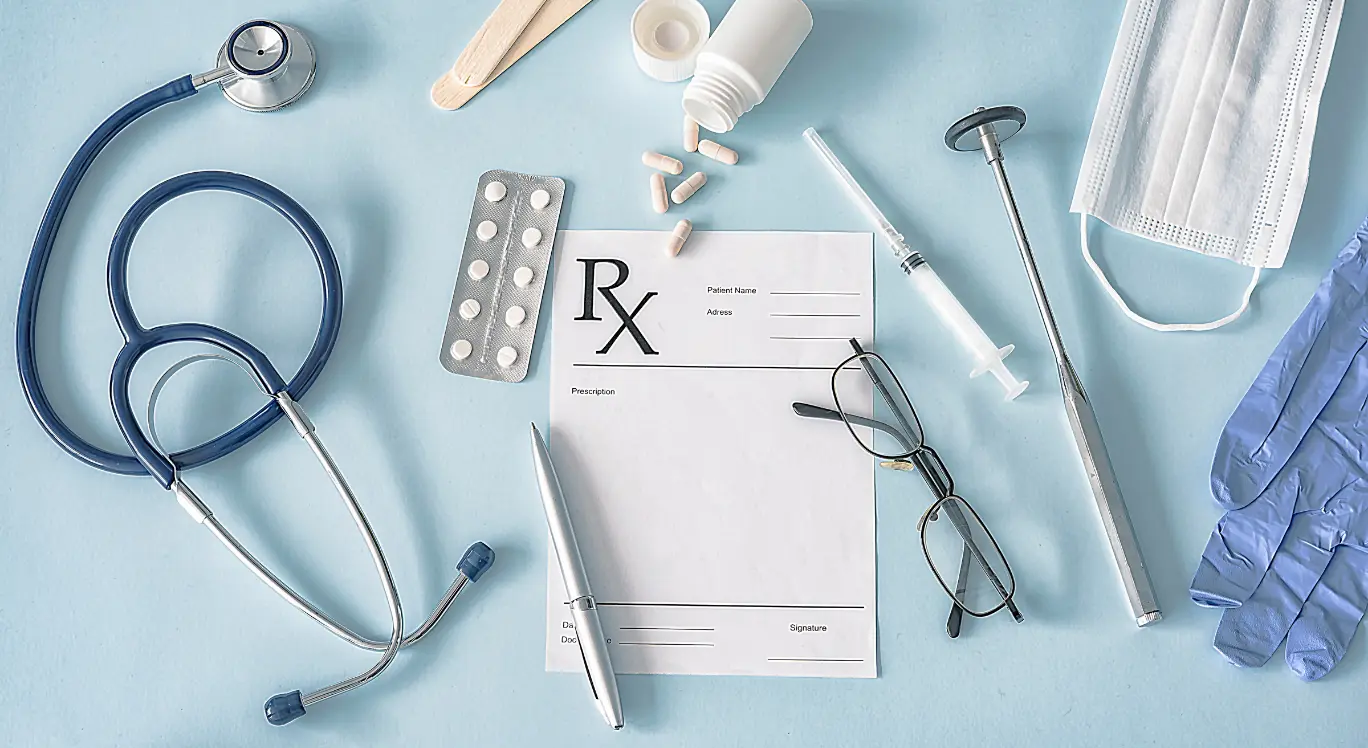Medical and dental practice flatlay: stethoscope, prescription pad, syringe and PPE used to illustrate Australian medical accounting and tax for doctors, dentists and allied health