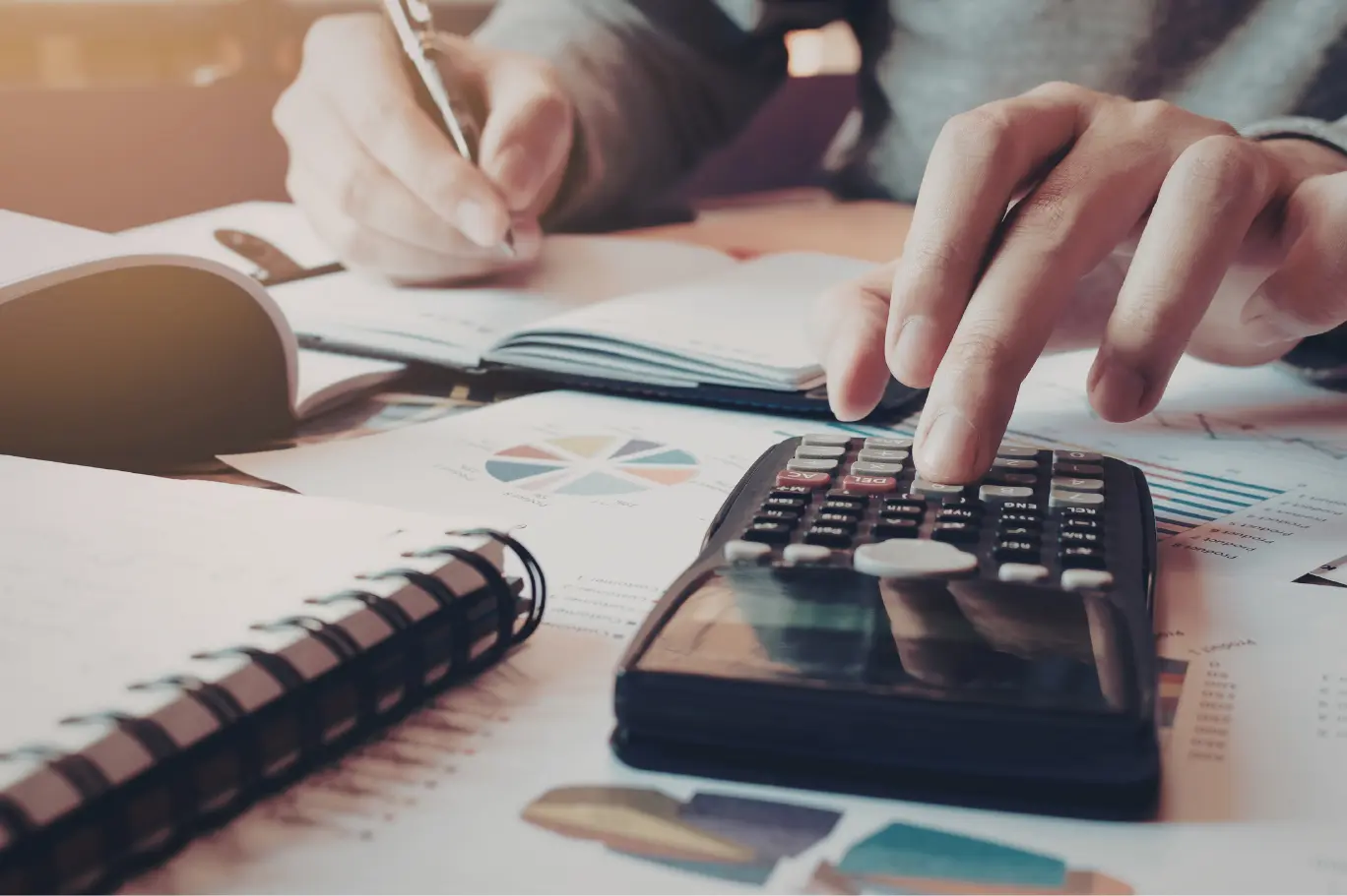 Perth tax planning session showing a calculator, pie chart and notebook used to model structure, super contributions and CGT timing levers before June 30