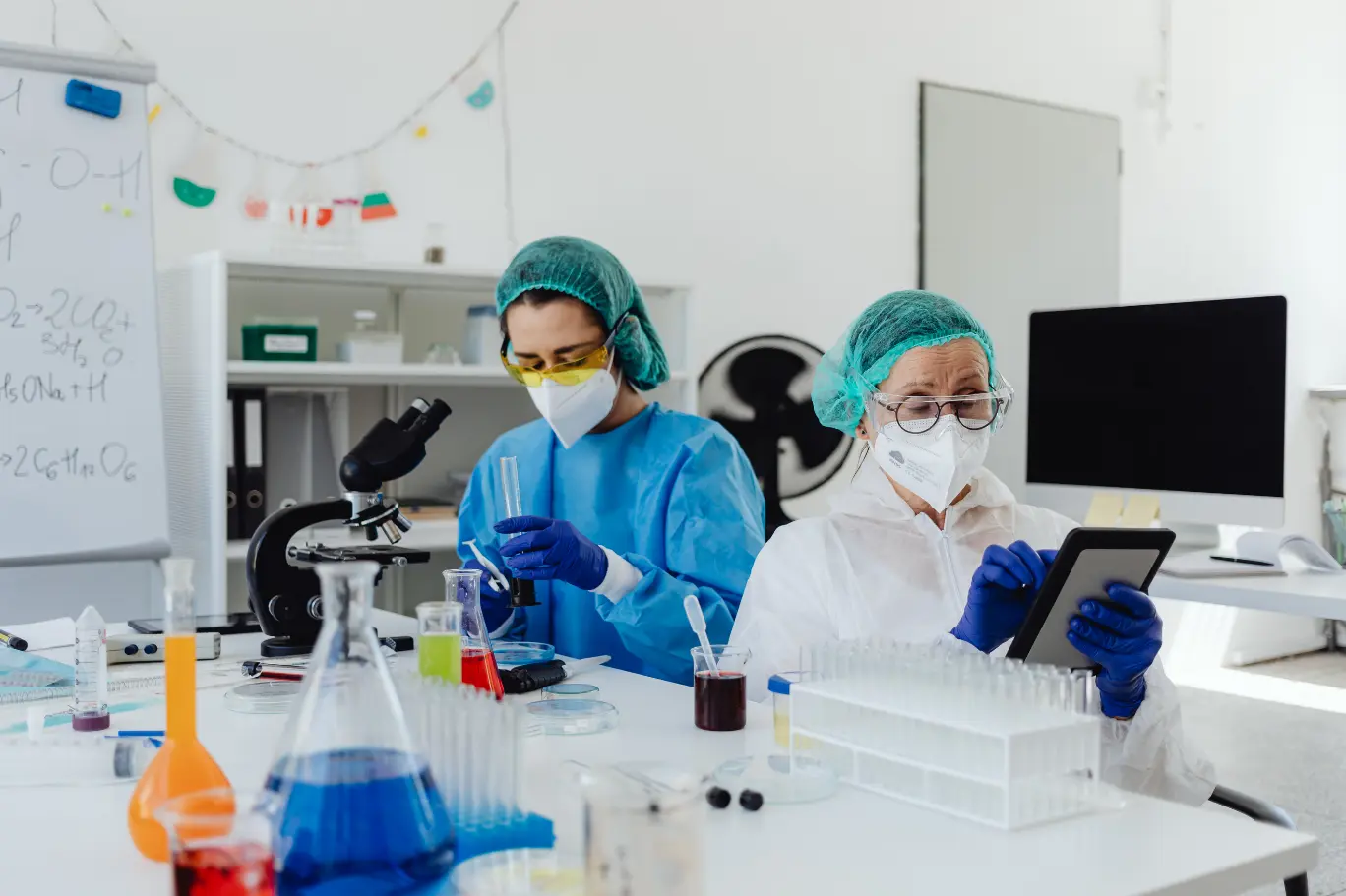 Australian laboratory researchers in PPE running experiments that qualify as eligible R&D Tax Incentive activities for AusIndustry registration and the 43.5% refundable offset