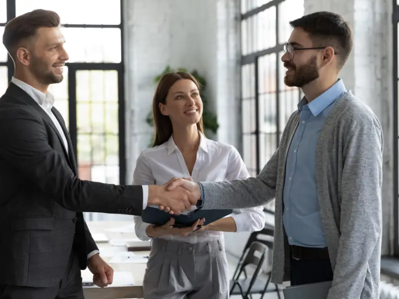 Australian Pty Ltd company registration handover, the new founder shaking hands with the KSH TAX ASIC-registered agent in a modern boardroom
