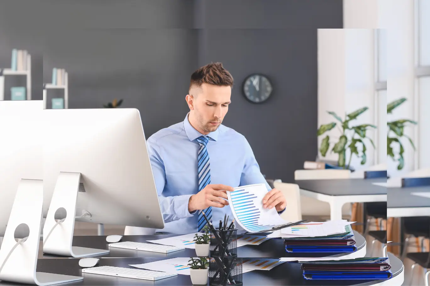 Australian Virtual CFO reviewing a financial chart, KPI dashboard and 13-week cashflow forecast from a modern office workstation